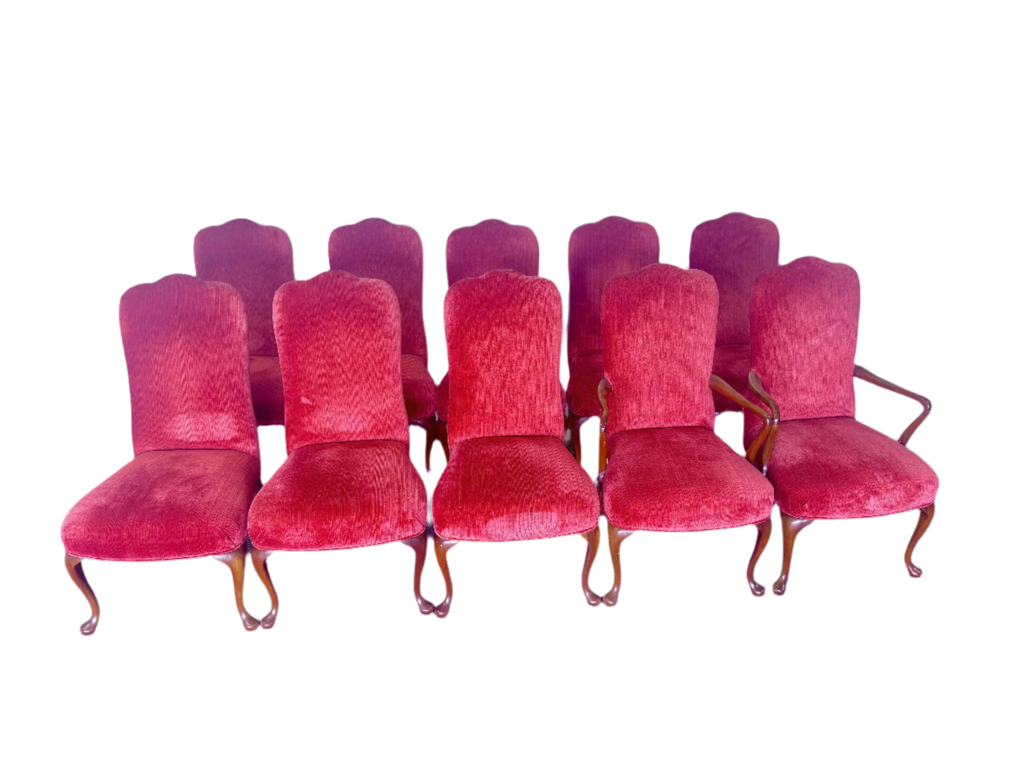 Set of red velvet chairs arranged in a row against a plain wall.