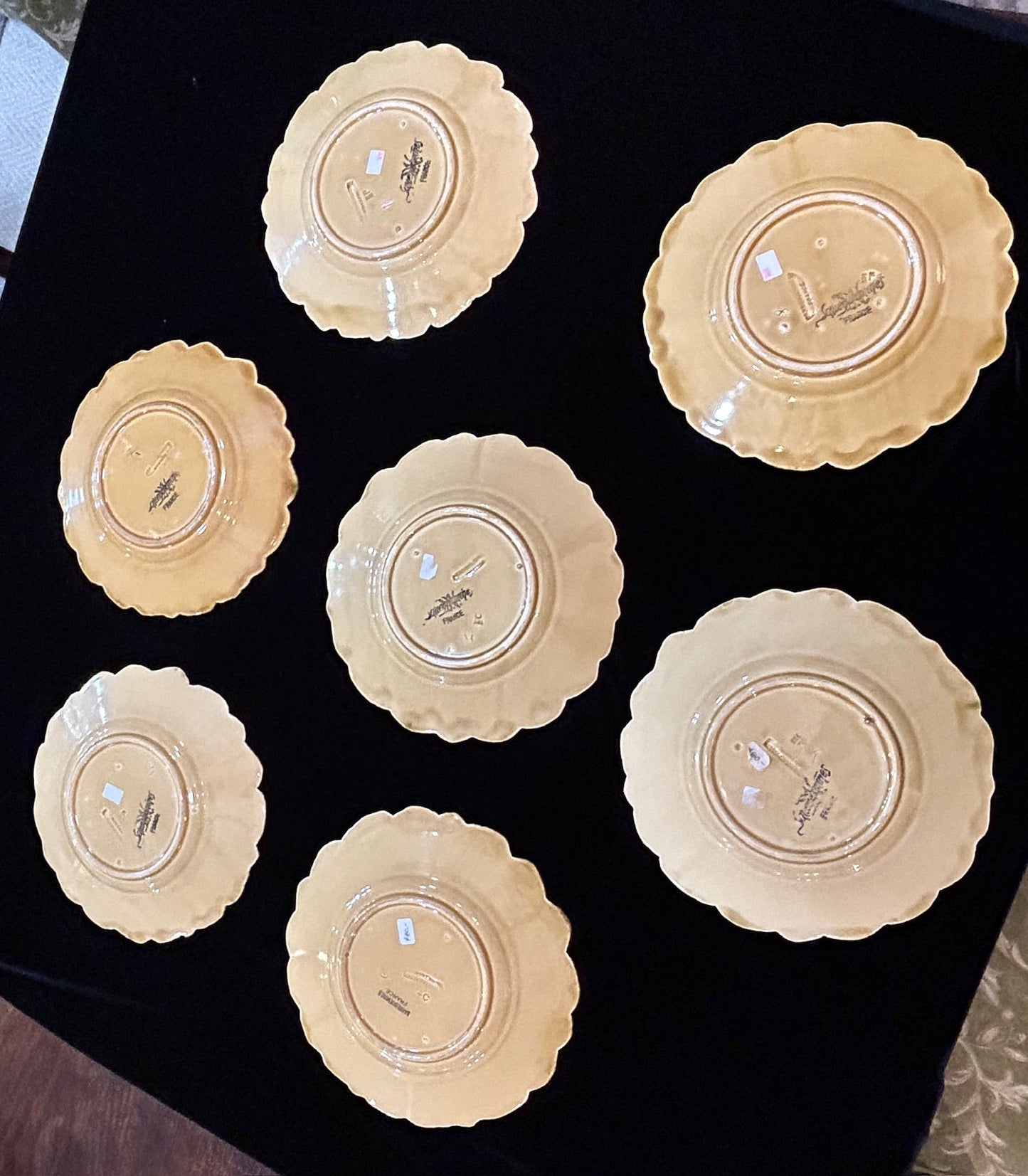 Grand Expressions Gallery and Home Store set of 7 antique French Sarreguemines majolica plates showing back markings.
