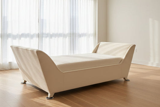 Beige sofa in a showroom setting with other furniture in the background