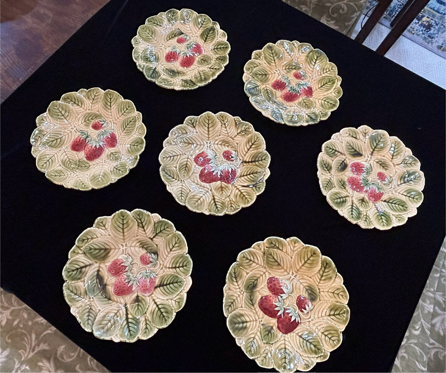 Grand Expressions Gallery and Home Store set of 7 antique French Sarreguemines majolica plates with strawberry motif.