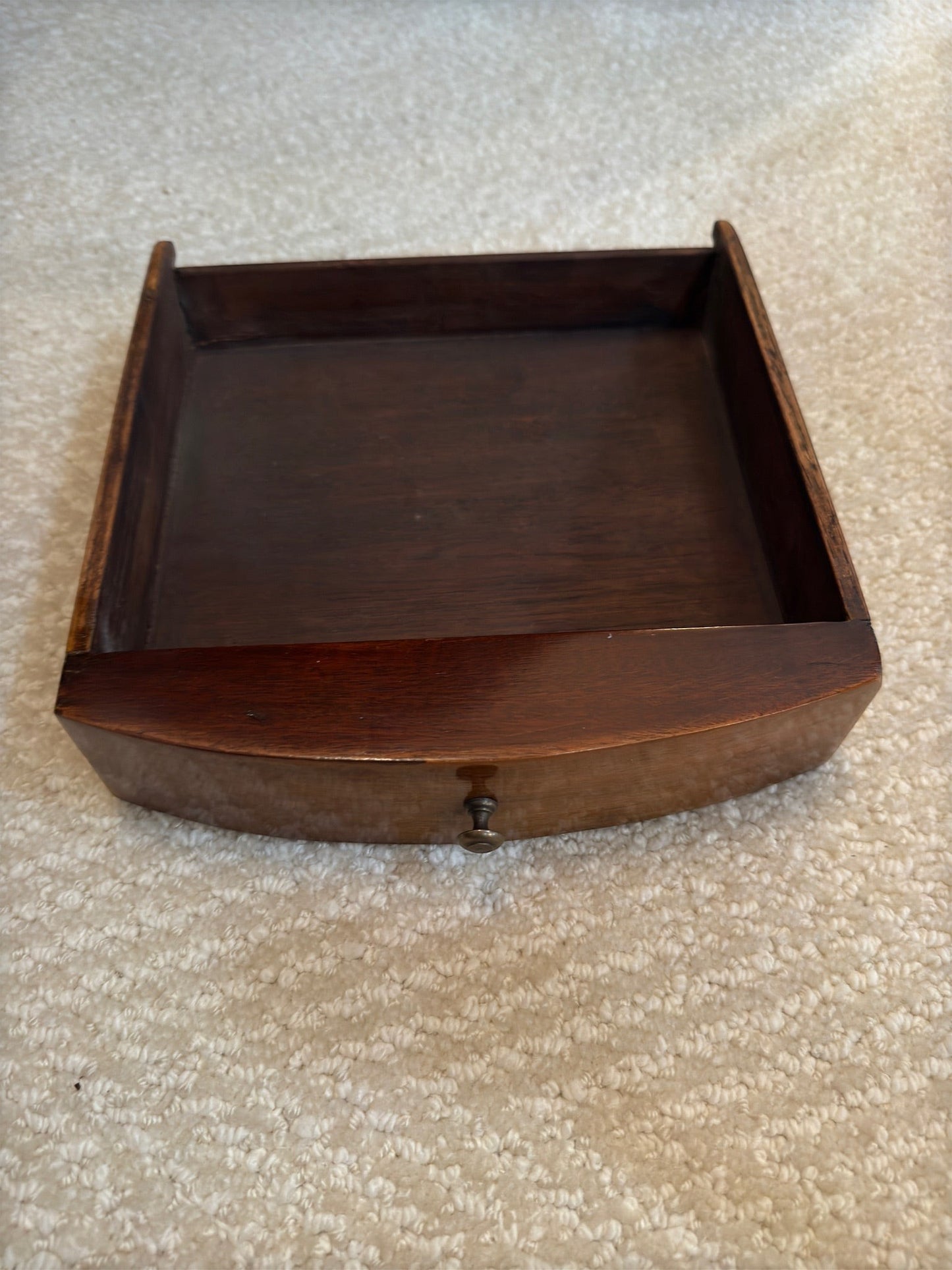 Grand Expressions Gallery and Home Store antique wooden tea table drawer with a curved front and small metal knob.