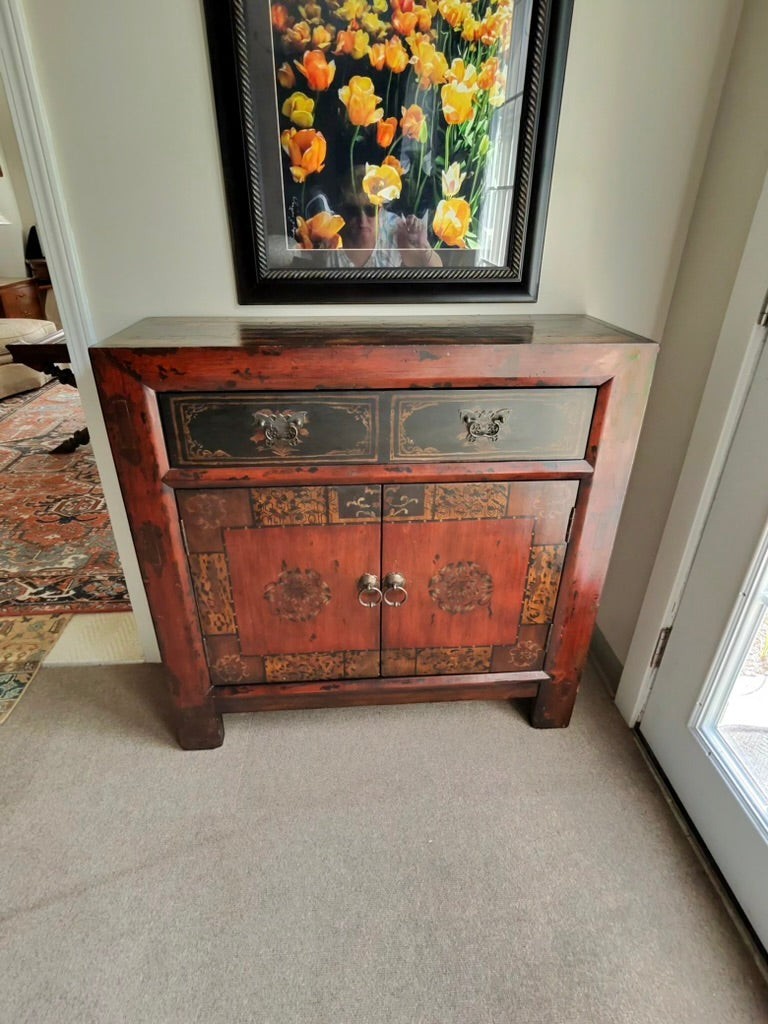 Grand Expressions Gallery and Home Store Asian style cabinet in red and black with drawer and cabinet storage.