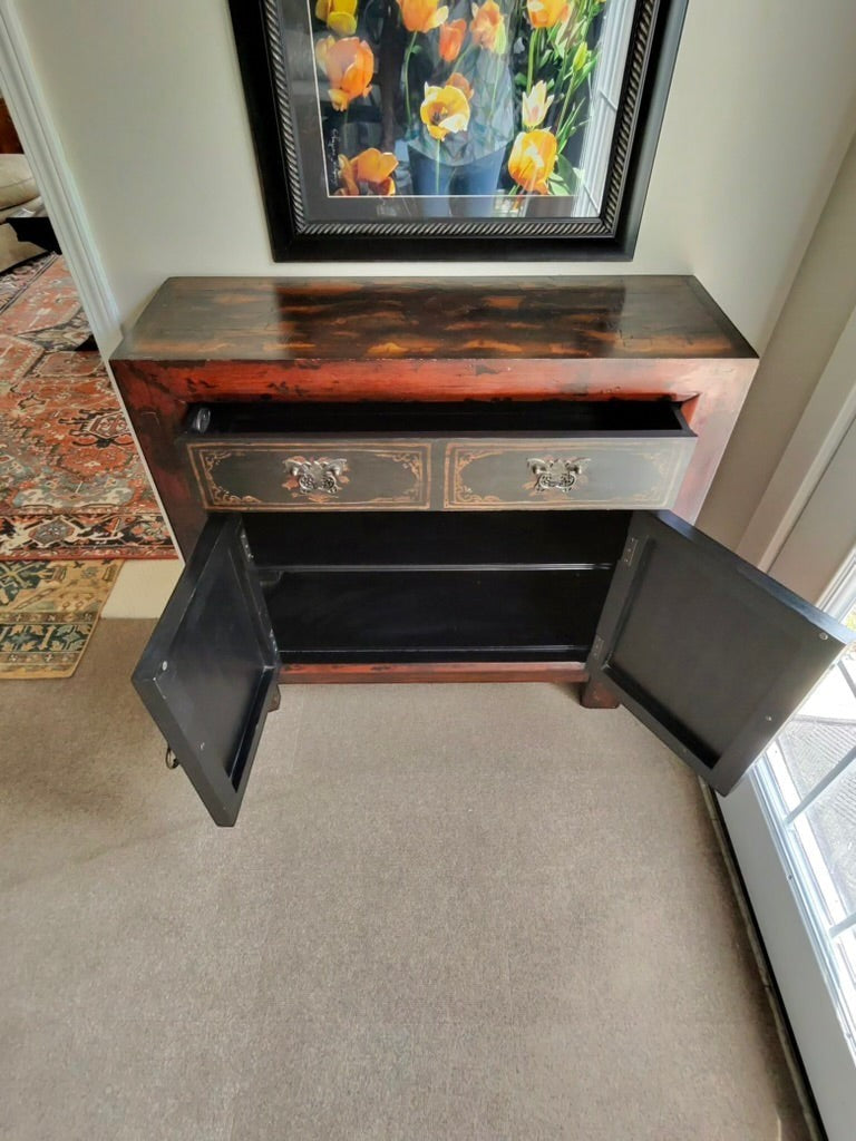 Grand Expressions Gallery and Home Store Asian style cabinet in red and black with a drawer and storage doors.