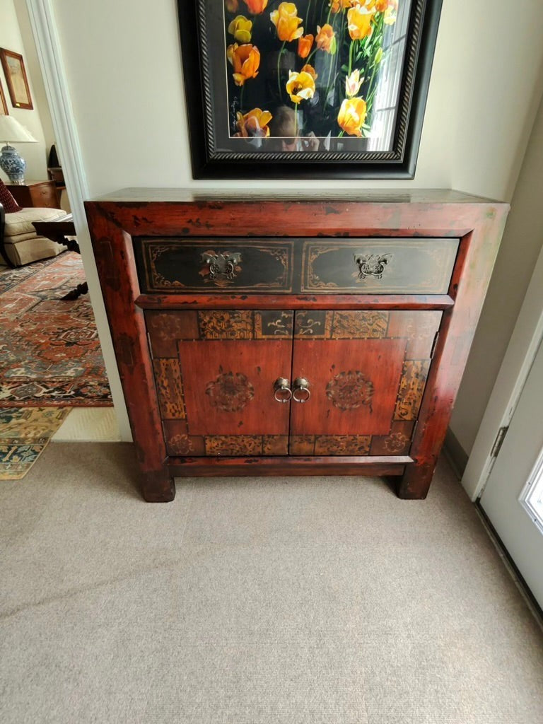 Grand Expressions Gallery and Home Store Asian style cabinet in red and black with decorative drawer and doors.