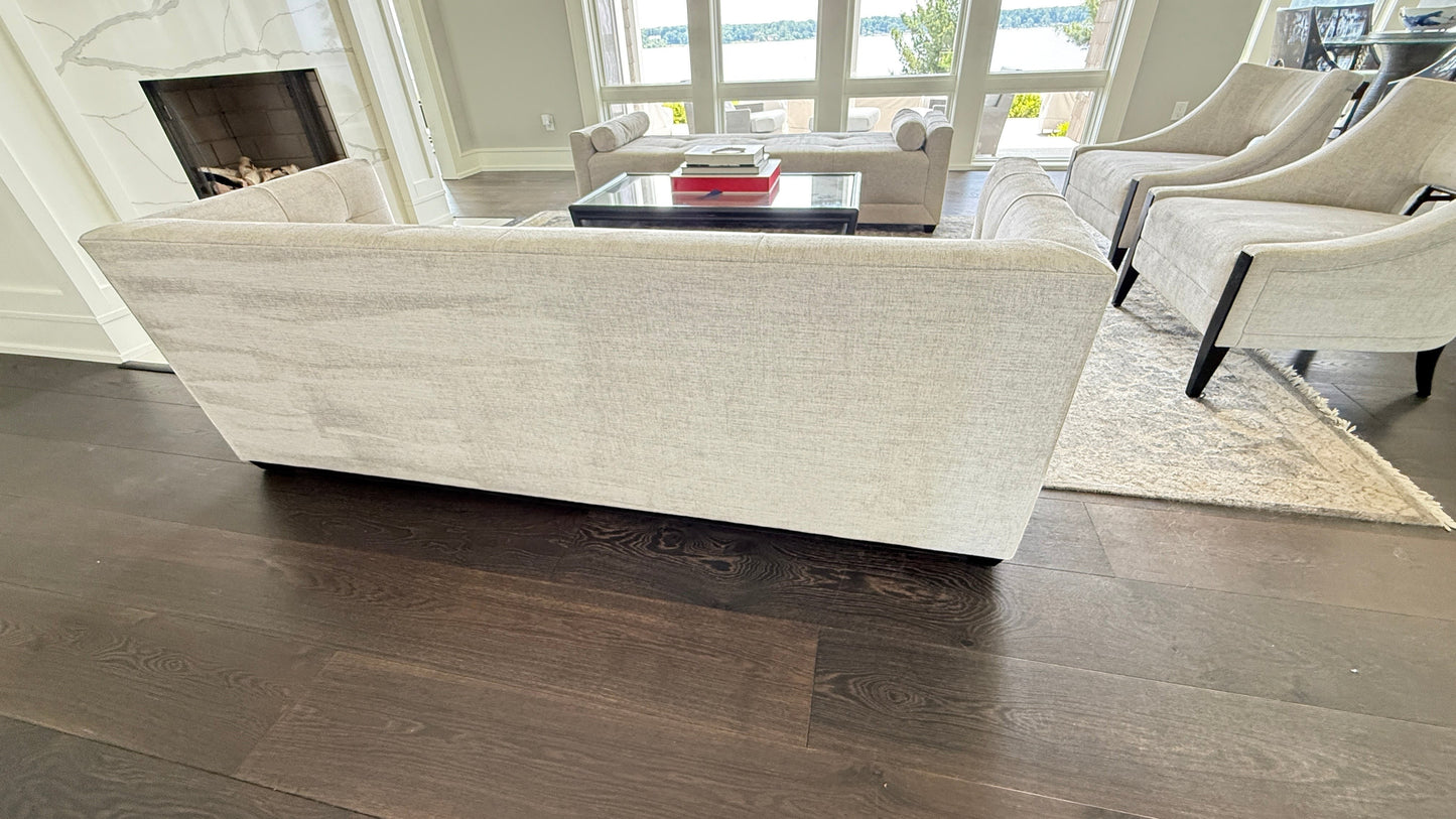 Grand Expressions Gallery and Home Store Baker Paris Loveseat with single stitch detail in a modern living room.