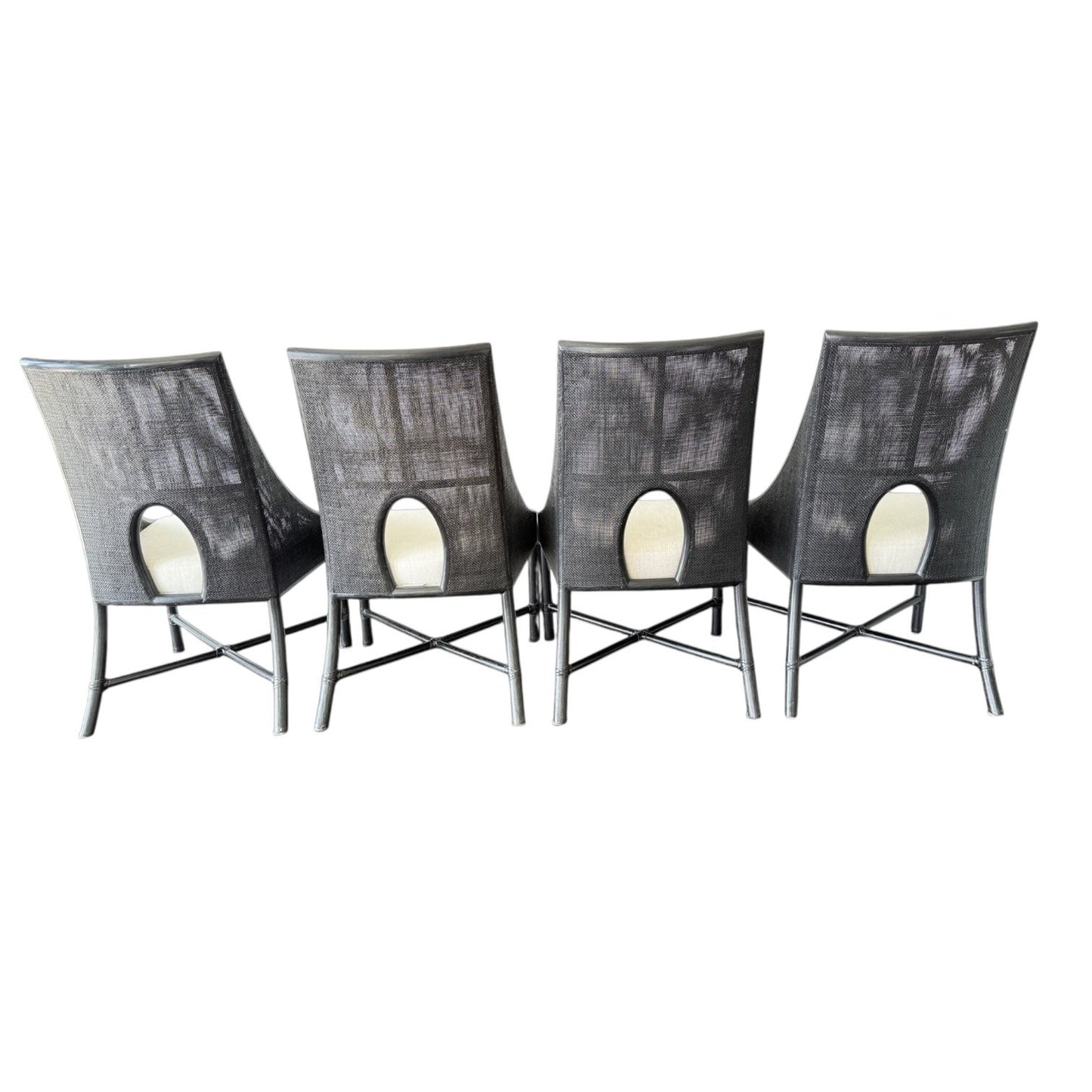 Set of 4 Barbara Barry for McGuire No. M-261 caned dining chairs in dark tobacco rattan with ecru linen seats.