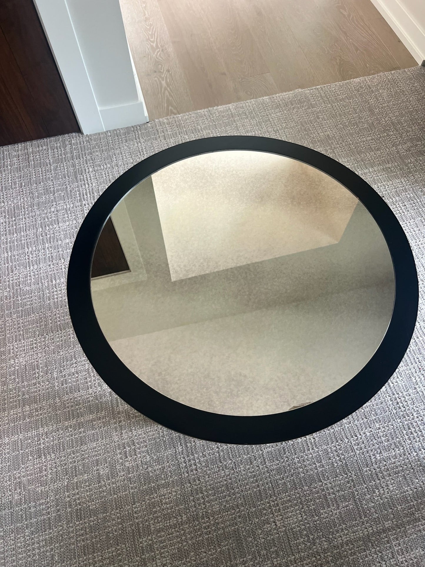 Grand Expressions Gallery and Home Store Bernhardt round accent table featuring a dark frame and reflective mirror top.