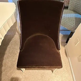 Grand Expressions Gallery and Home Store brown mohair armless chair with nailhead trim and white lacquer saber legs.
