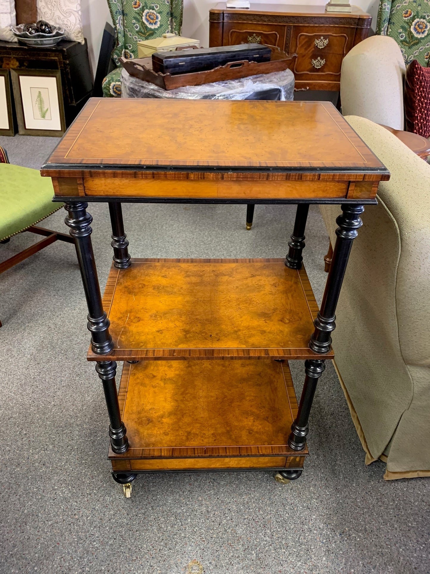 Grand Expressions Gallery and Home Store Italian burled wood triple shelf with black trim, inlay edge, and casters.