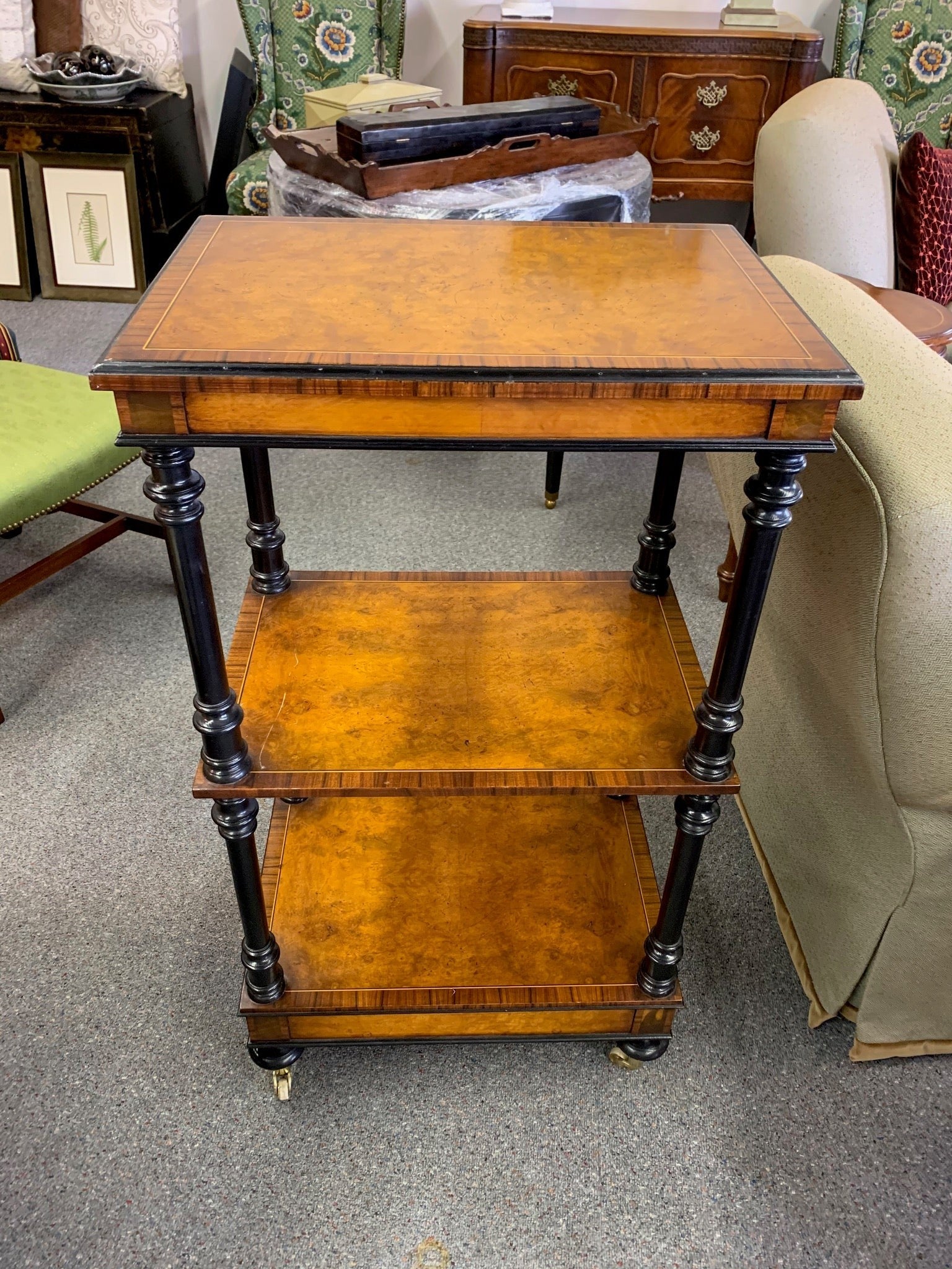 Grand Expressions Gallery and Home Store Italian burled wood triple shelf with black trim, inlay edge, and casters.