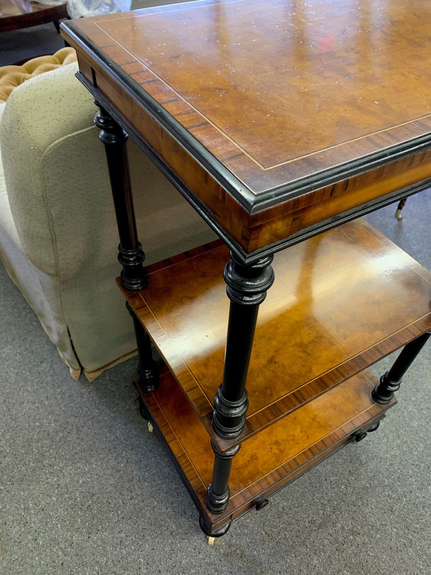 Grand Expressions Gallery and Home Store Italian burled wood triple shelf with black trim and inlay on casters.
