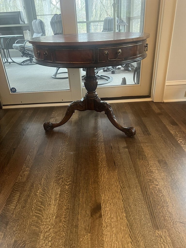 Grand Expressions Gallery and Home Store vintage Chippendale accent table with a round red leather top and carved base.