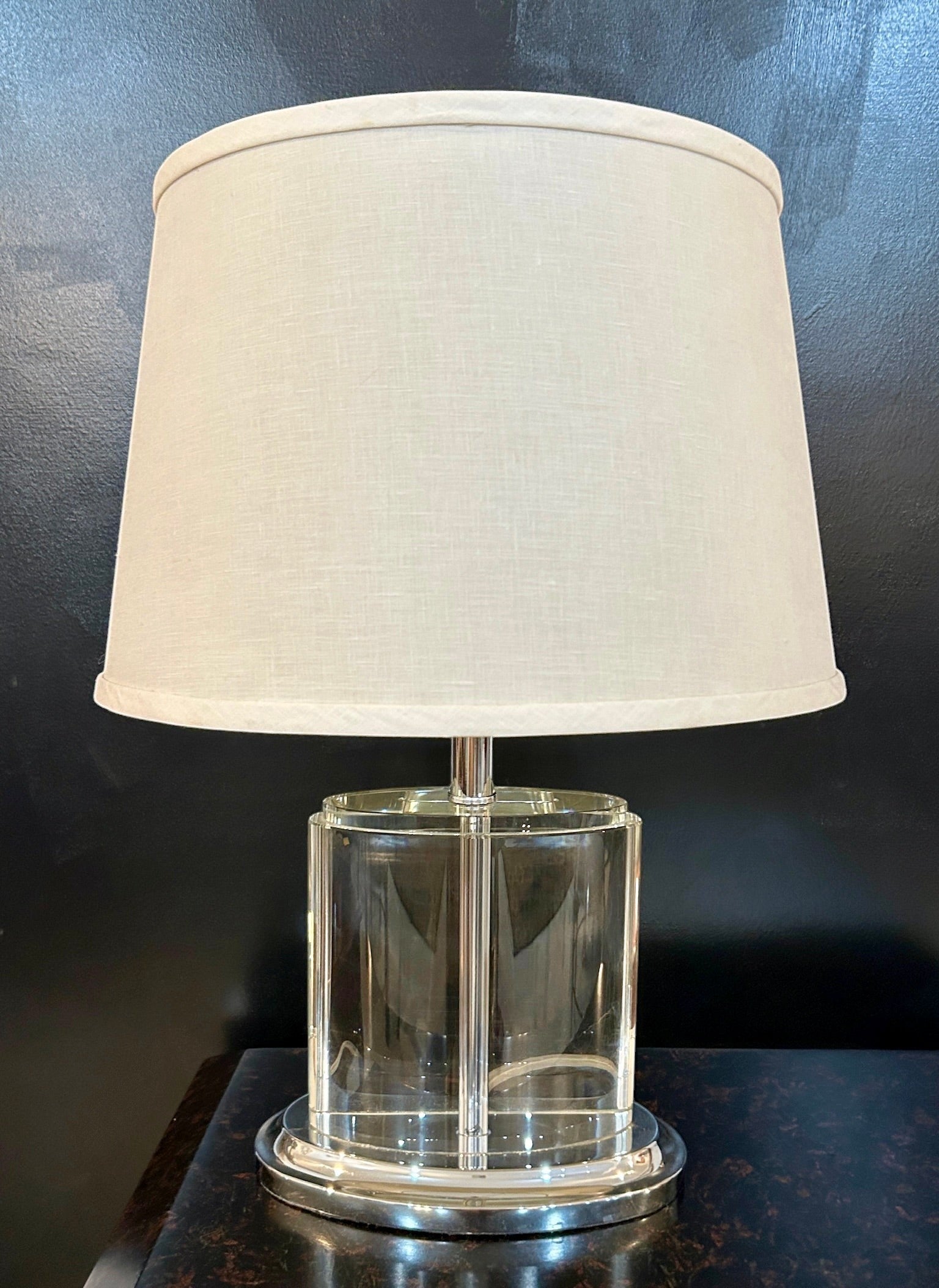 Grand Expressions Gallery and Home Store oval crystal table lamp with chrome base and off-white fabric shade.