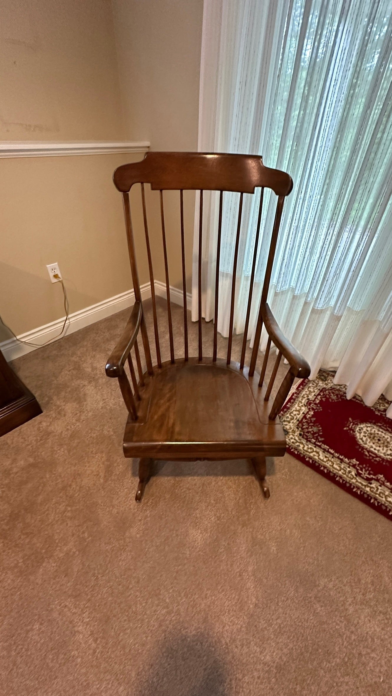 Vintage Ethan Allen wood rocking chair in brown, featuring a spindle back design from Grand Expressions Gallery and Home Store