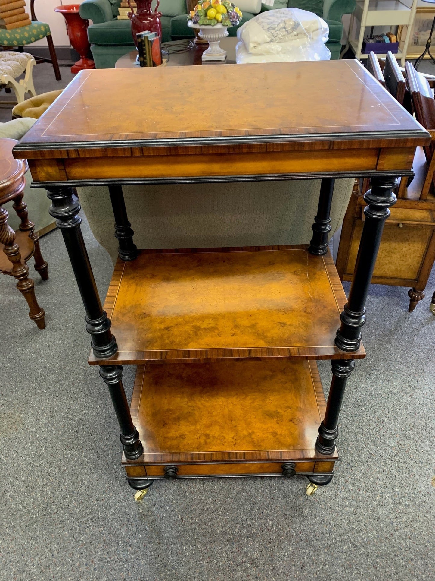 Grand Expressions Gallery and Home Store Italian burled wood triple shelf with black trim, inlay edge, and casters.