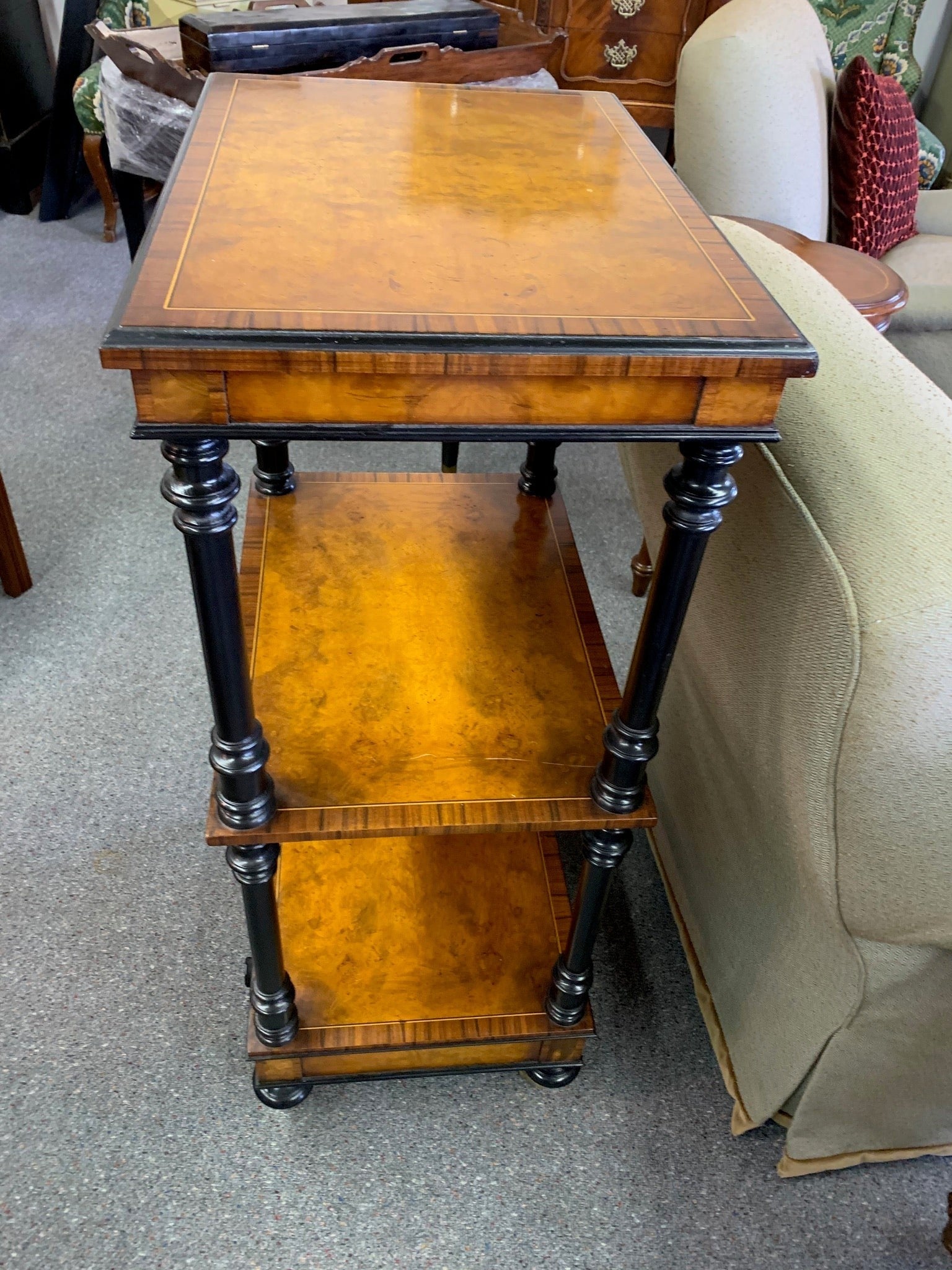 Grand Expressions Gallery and Home Store Italian burled wood triple shelf unit with black trim and inlay on casters.