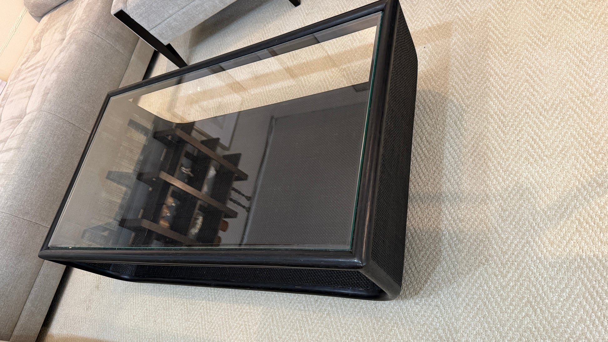 Grand Expressions Gallery and Home Store McGuire Ladera coffee table with black woven base and clear glass top.