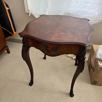 Grand Expressions Gallery and Home Store Louis XV side table with wood grain top, ormolu trim, and cabriole legs.