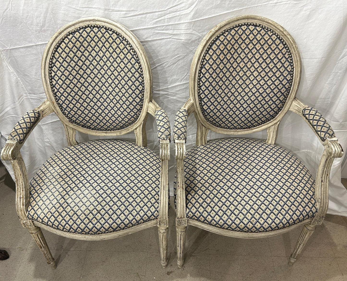 Grand Expressions Gallery and Home Store pair of 1770 Louis XVI fauteuils with blue and cream needlepoint upholstery.