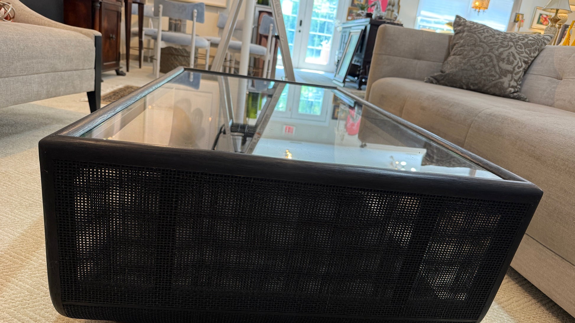 Grand Expressions Gallery and Home Store McGuire Ladera coffee table with black woven base and glass top.