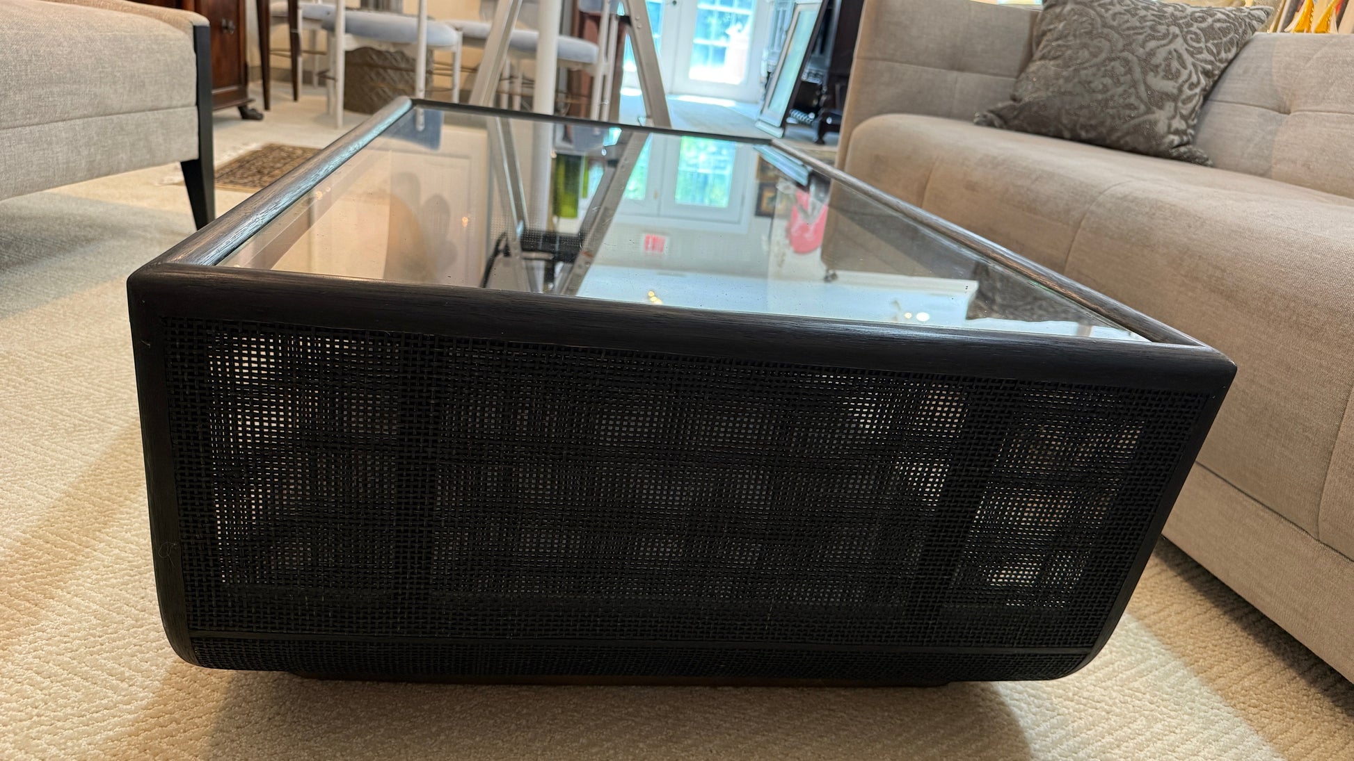 Grand Expressions Gallery and Home Store McGuire Ladera coffee table with black mesh base and glass top.