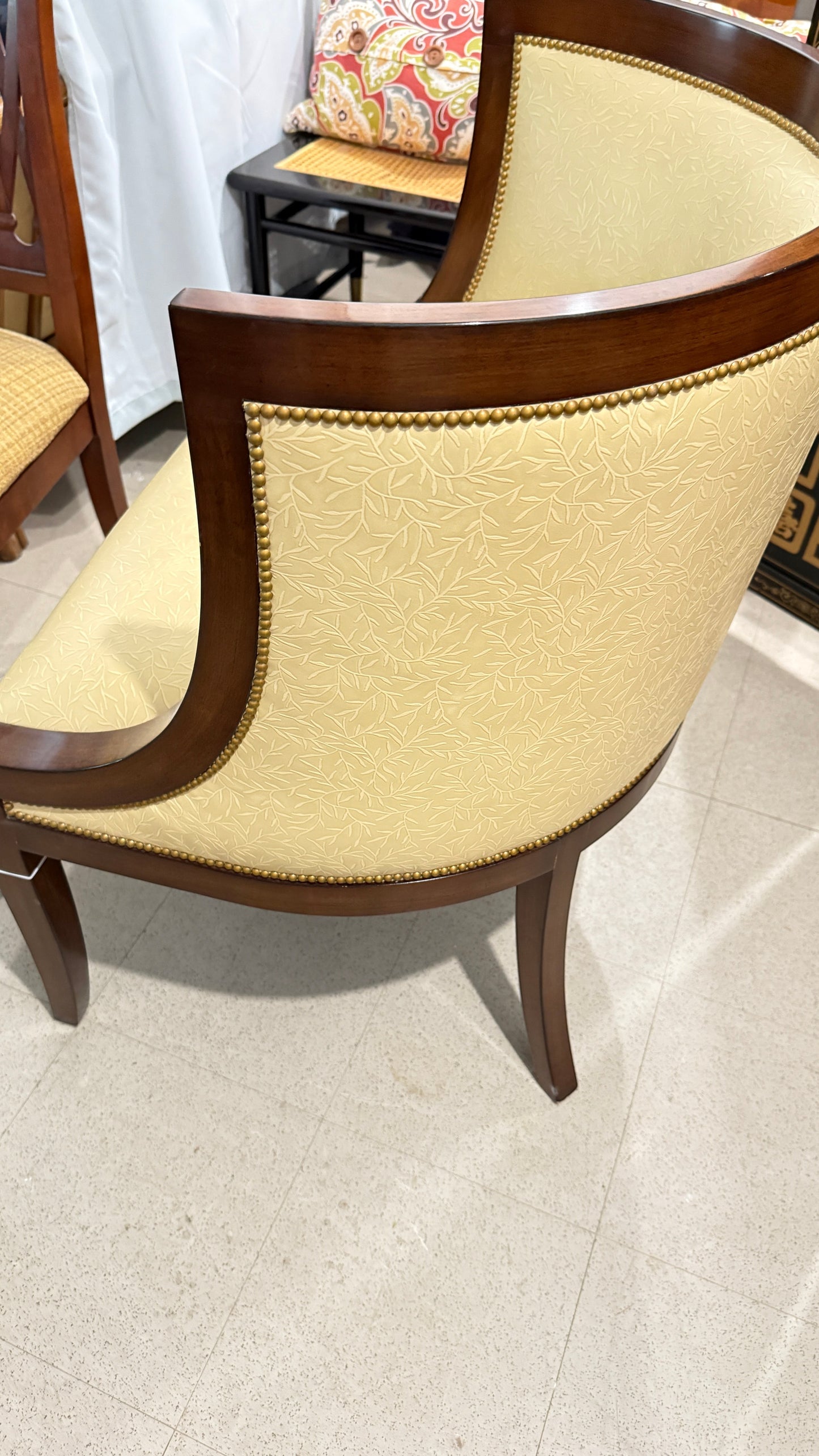 Grand Expressions Gallery and Home Store Nancy Corzine butter yellow accent chair with mahogany wood and nailhead trim