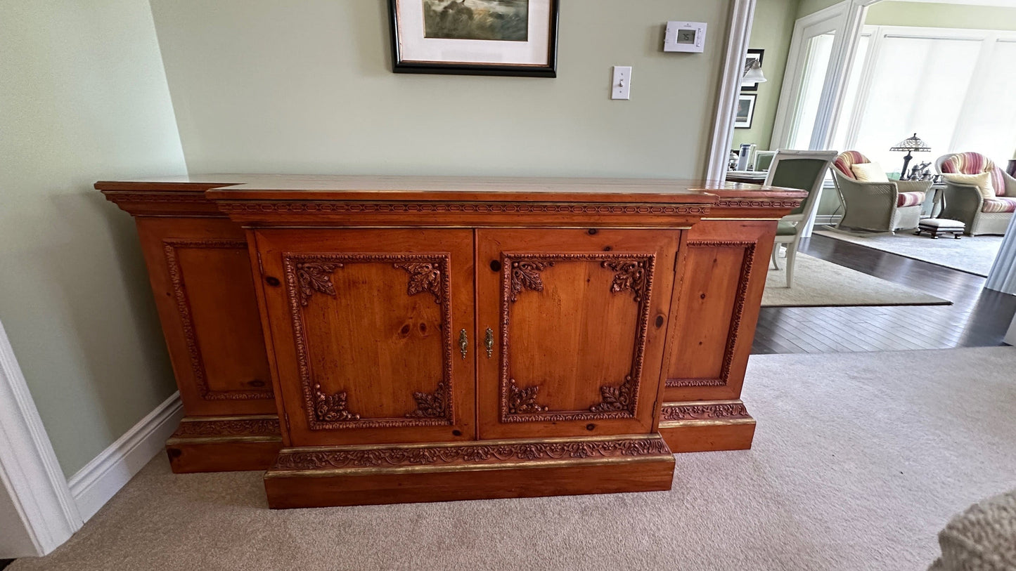 Grand Expressions Gallery and Home Store ornate wooden credenza with intricate carvings and gold-toned accents.