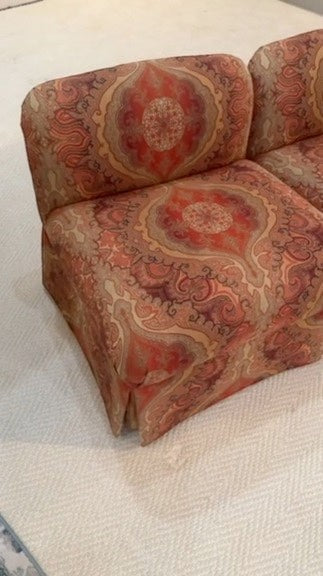 Pair of Grand Expressions Gallery and Home Store bohemian paisley slipper chairs in warm orange and tan tones.
