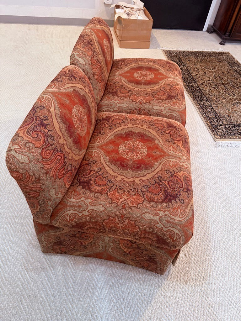 Pair of Grand Expressions Gallery and Home Store bohemian slipper chairs in orange and red paisley fabric