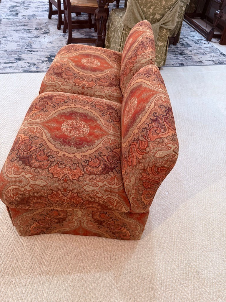 Pair of Grand Expressions Gallery and Home Store bohemian slipper chairs featuring an intricate orange paisley pattern.