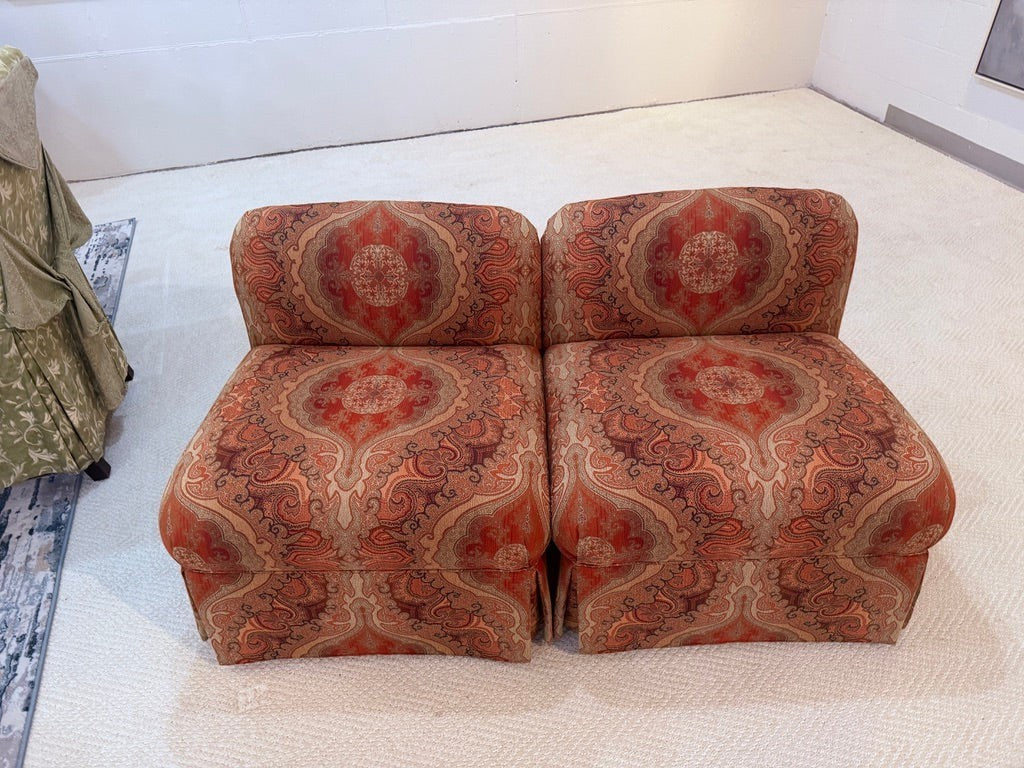 Pair of Grand Expressions Gallery and Home Store bohemian paisley slipper chairs in warm orange and red tones.