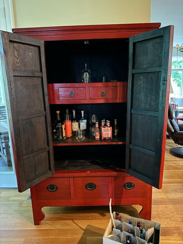 Grand Expressions Gallery and Home Store red lacquer elm wood armoire with brass hardware and interior shelving.