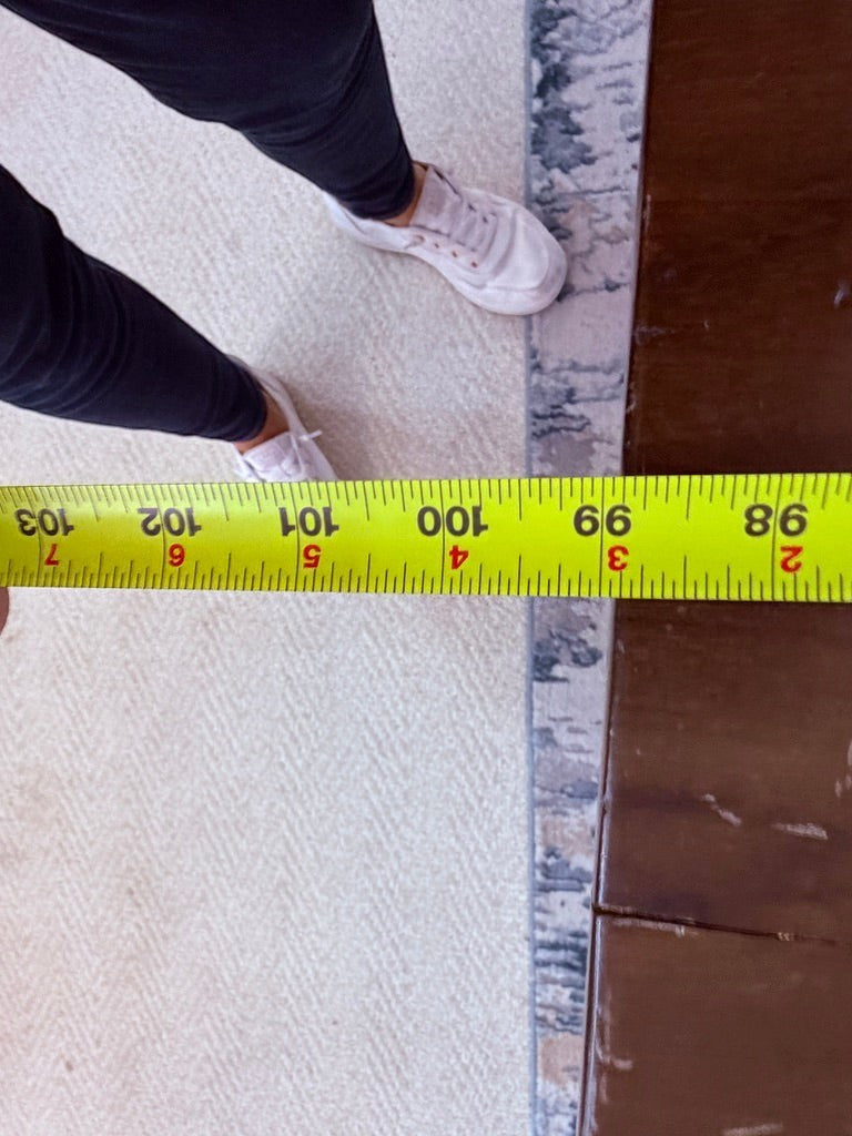 Grand Expressions Gallery and Home Store extra long natural slab wood dining table with measuring tape at 99 inches.