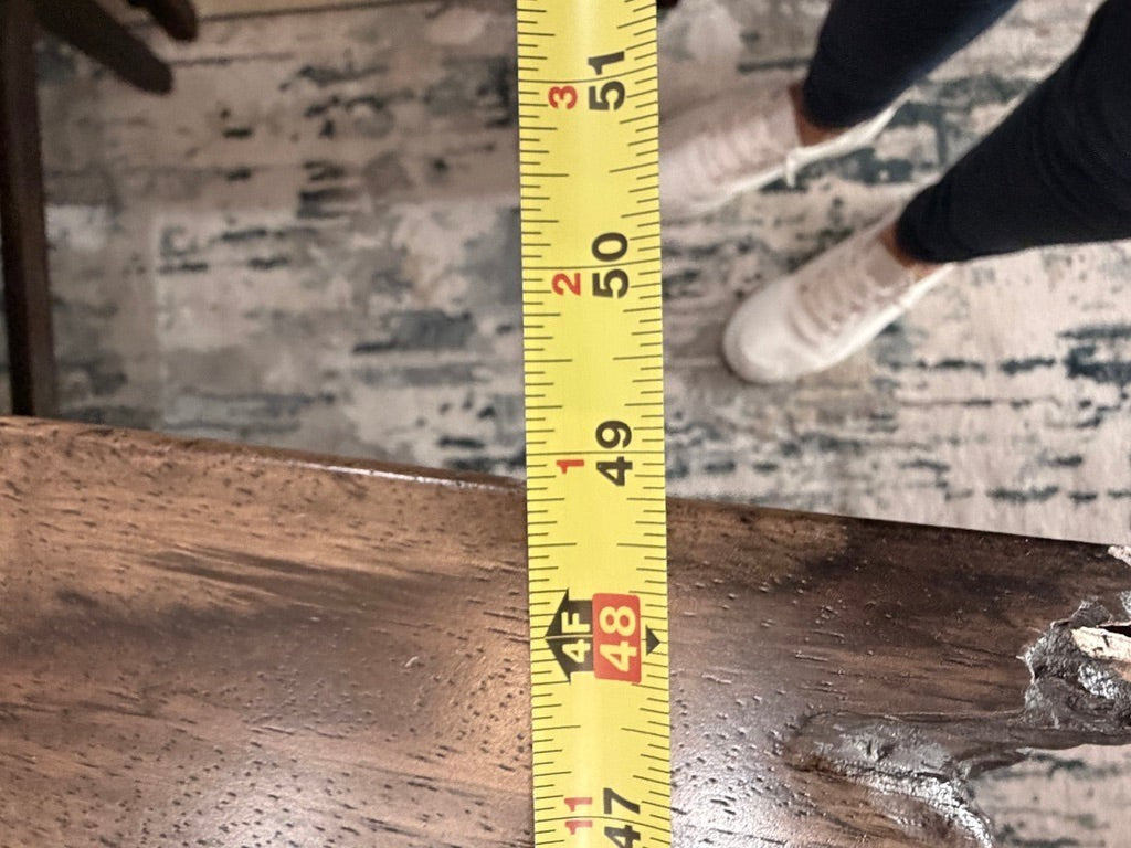 Grand Expressions Gallery and Home Store natural slab wood dining table showing width measurement with tape measure