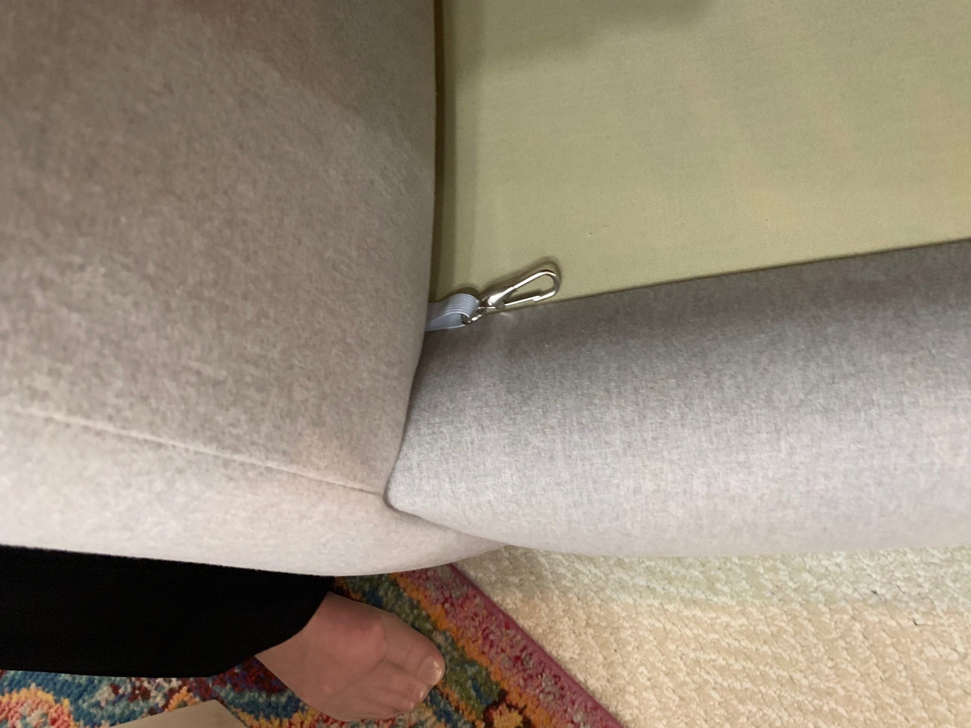 Close-up of the beige fabric upholstery and shelter arm detail on The Sullivan Sofa by Grand Expressions Gallery and Home Store.