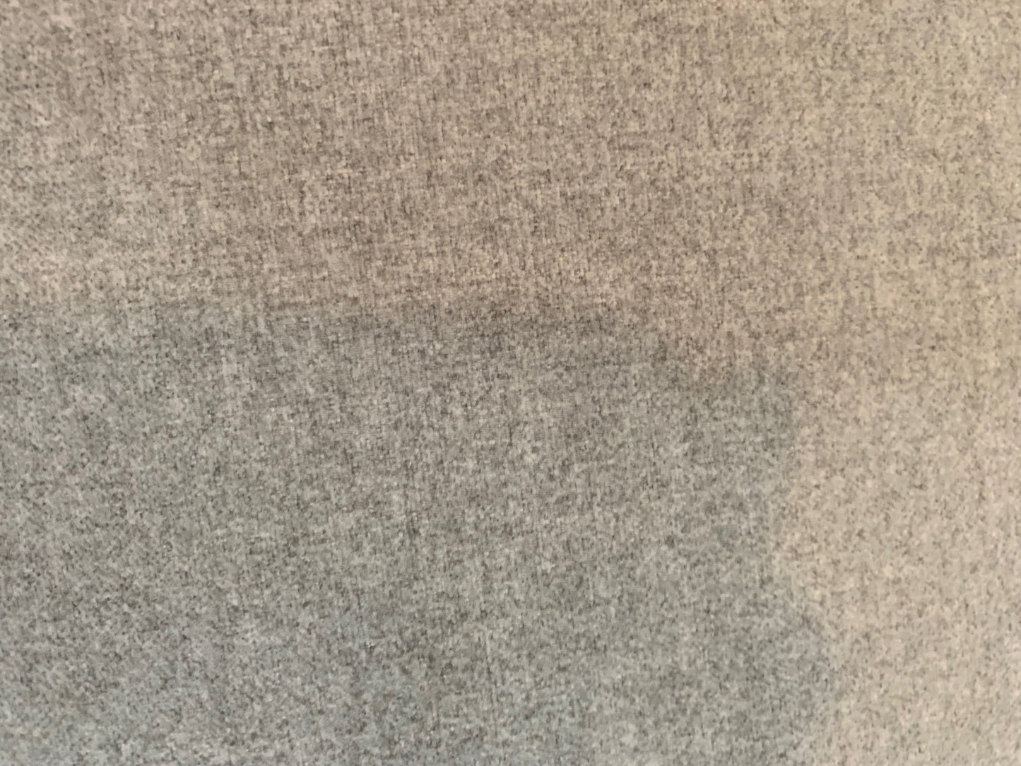 Close-up of the grey textured fabric upholstery on The Sullivan Sofa by Grand Expressions Gallery and Home Store.