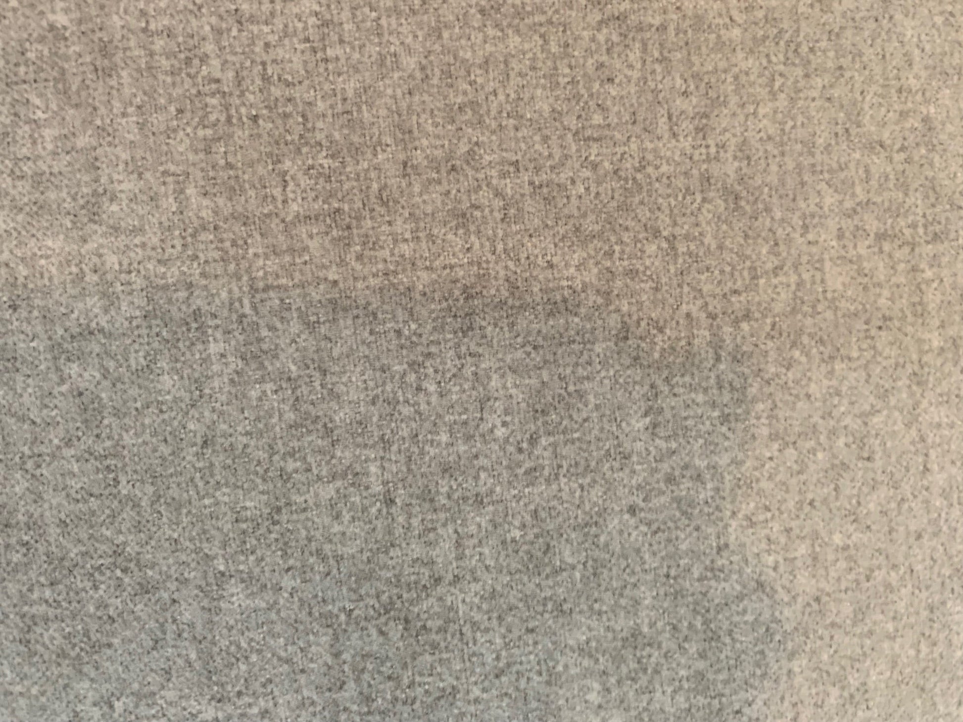 Close-up of the grey textured fabric upholstery on The Sullivan Sofa by Grand Expressions Gallery and Home Store.