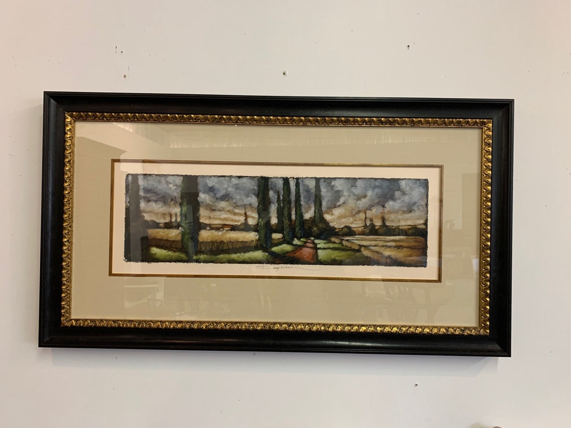 Grand Expressions Gallery and Home Store original torn edge watercolor landscape in a decorative black and gold frame.