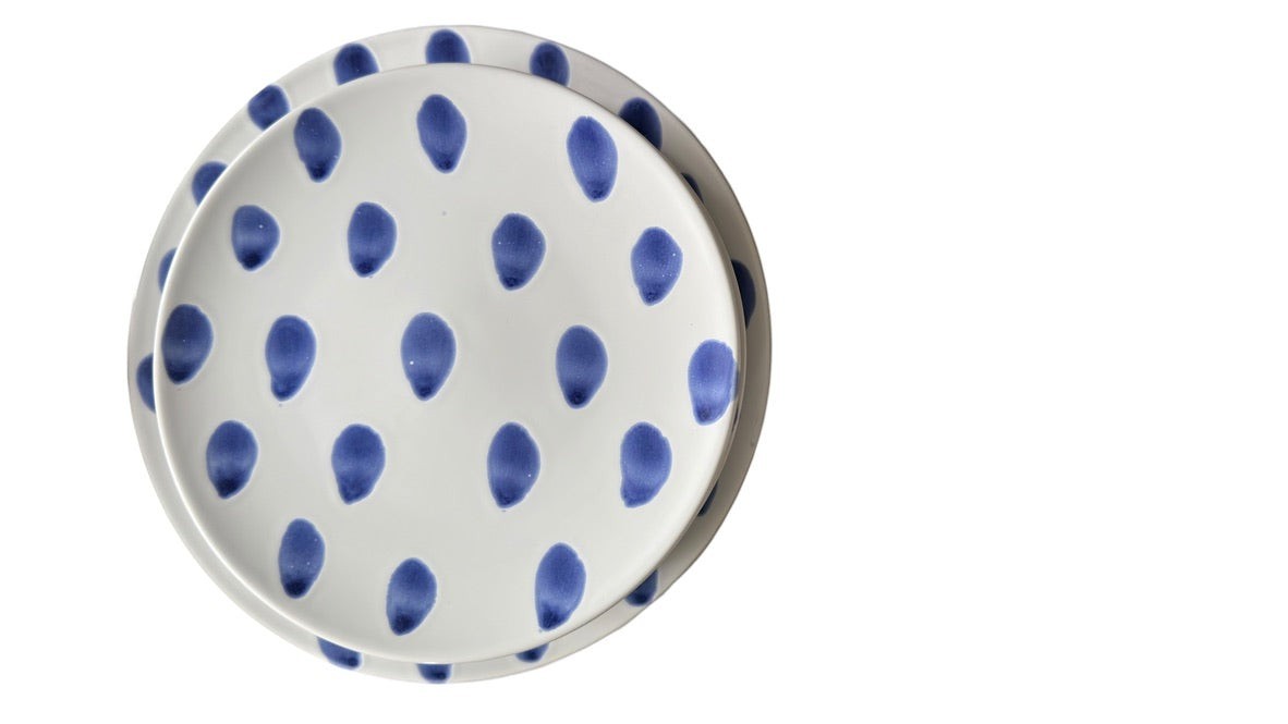 Grand Expressions Gallery and Home Store Vietri blue and white ceramic dinner plates with a hand-painted dot pattern.