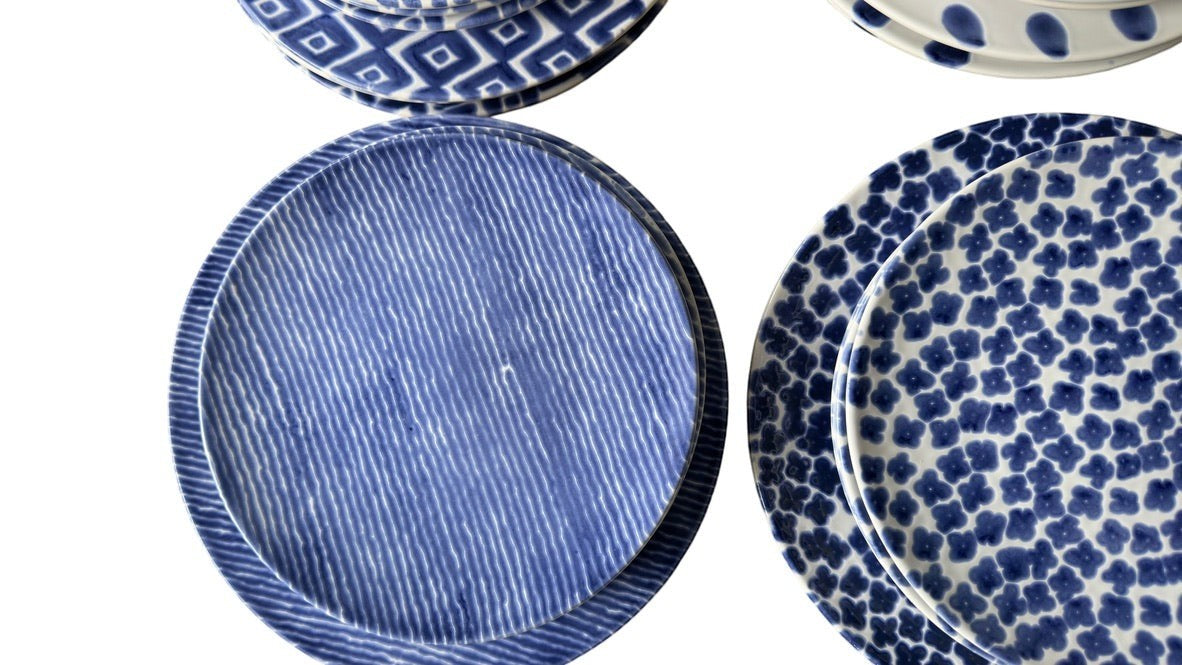 Grand Expressions Gallery and Home Store set of 6 blue and white Vietri dinner plates with assorted patterned designs.