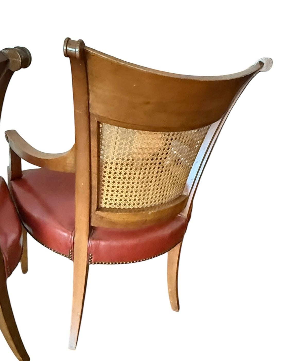 Grand Expressions Gallery and Home Store vintage Baker dining chairs with cane backrests and red leather seats.