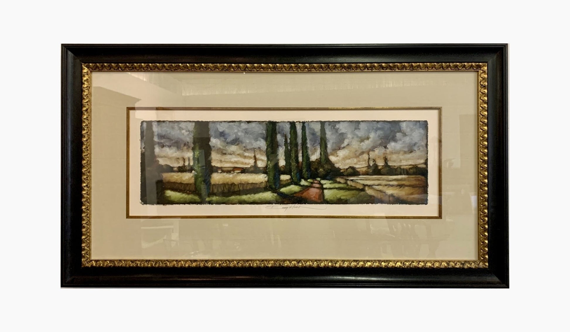 Grand Expressions Gallery and Home Store torn edge watercolor landscape painting in a custom black and gold frame.