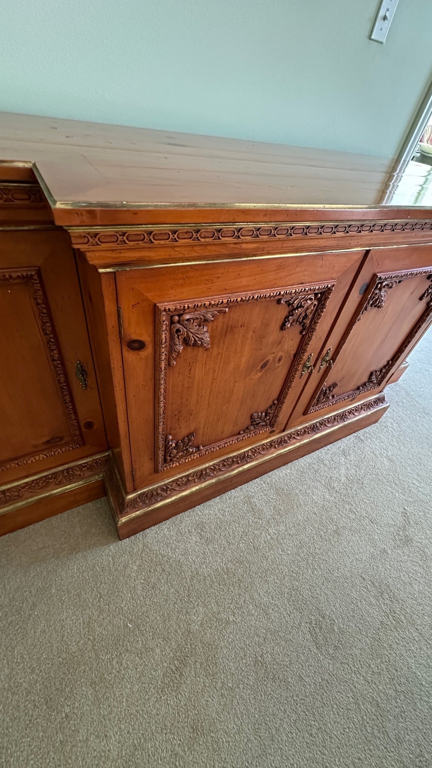 Grand Expressions Gallery and Home Store traditional wooden credenza with ornate carvings and gold-toned trim.